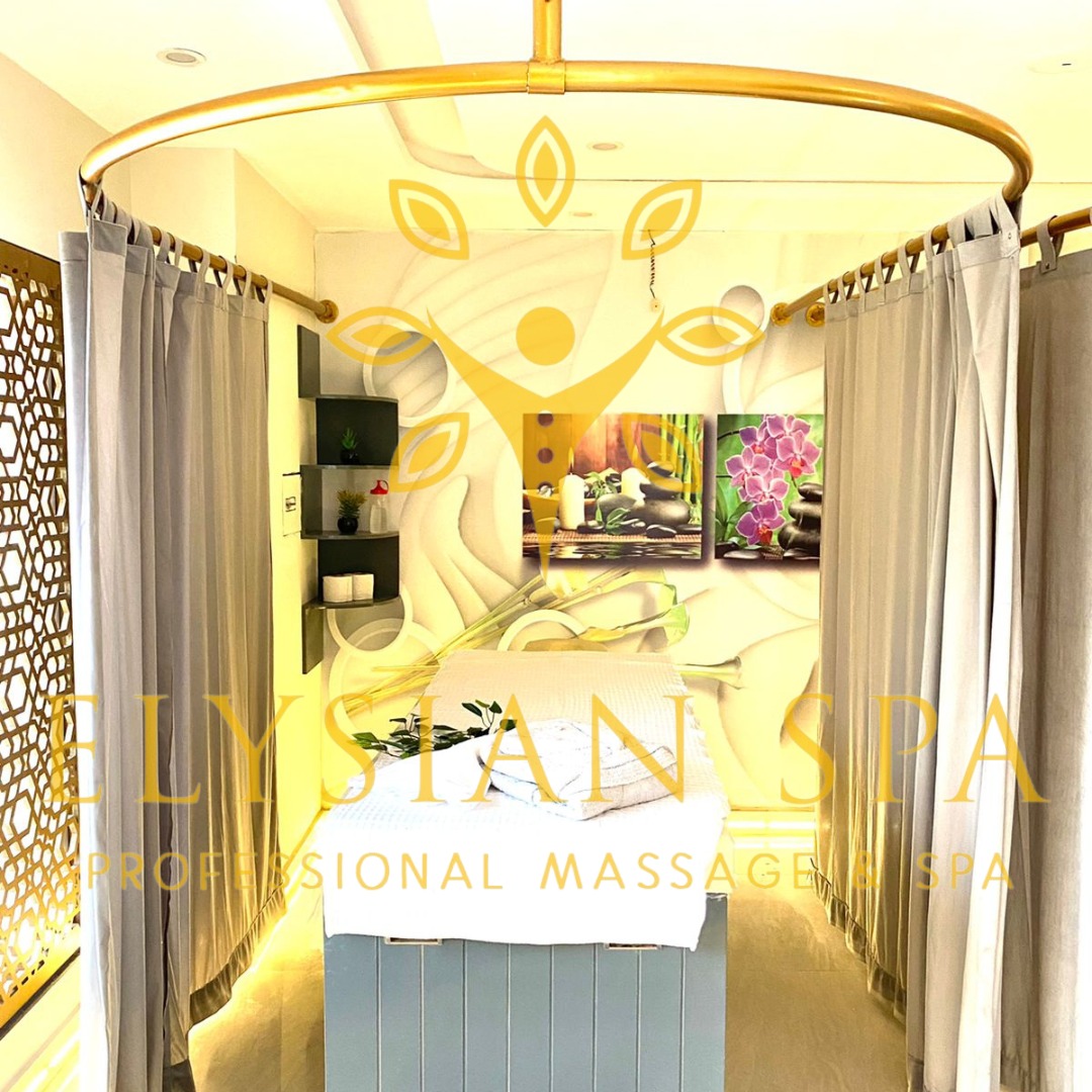 Serene massage room at Elysian Spa & Massage Center in F7 Islamabad featuring a comfortable bed, window curtains, and a tranquil ambiance.